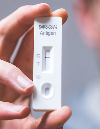 Adult administering a COVID-19 nasal self test